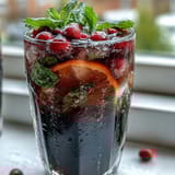 Grad Party Lemonade Bar with Customizable Flavor Add-Ins, featuring fresh fruit slices, herbs, and flavored syrups for a DIY drink station.