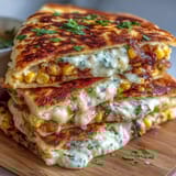 Crispy Cinco de Mayo Street Corn Quesadillas filled with roasted corn, melty cheese, and smoky chipotle crema drizzle.