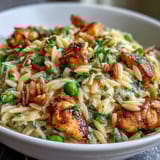 Golden sautéed chicken and zesty lemon orzo pasta simmered with sweet peas for a fresh spring meal.  