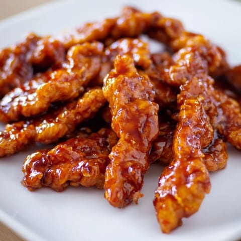 Tender glazed chicken, crisp veggies, and creamy sauce bundled in a soft tortilla for the Honey Sriracha Chicken Wrap.