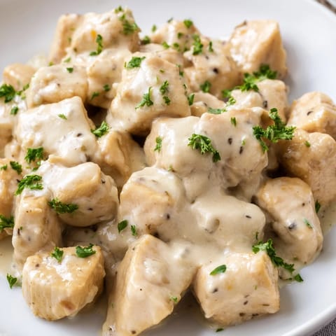Golden-brown Creamy Garlic Chicken Bites simmered in a velvety Parmesan sauce, perfect for a quick and satisfying dinner.  