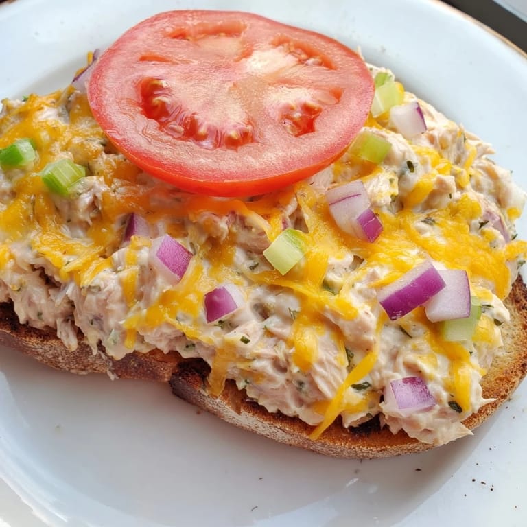 Oven-broiled Tuna Melt, a pescatarian delight served warm with tomato slices and creamy tuna.